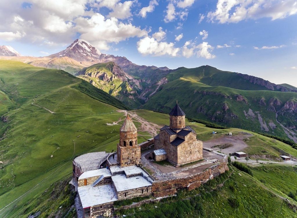 Trinity church on a hill in Kazbegi mountains