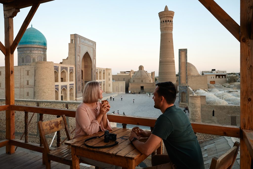 Couple drinking tea in a balcony in Uzbekistan