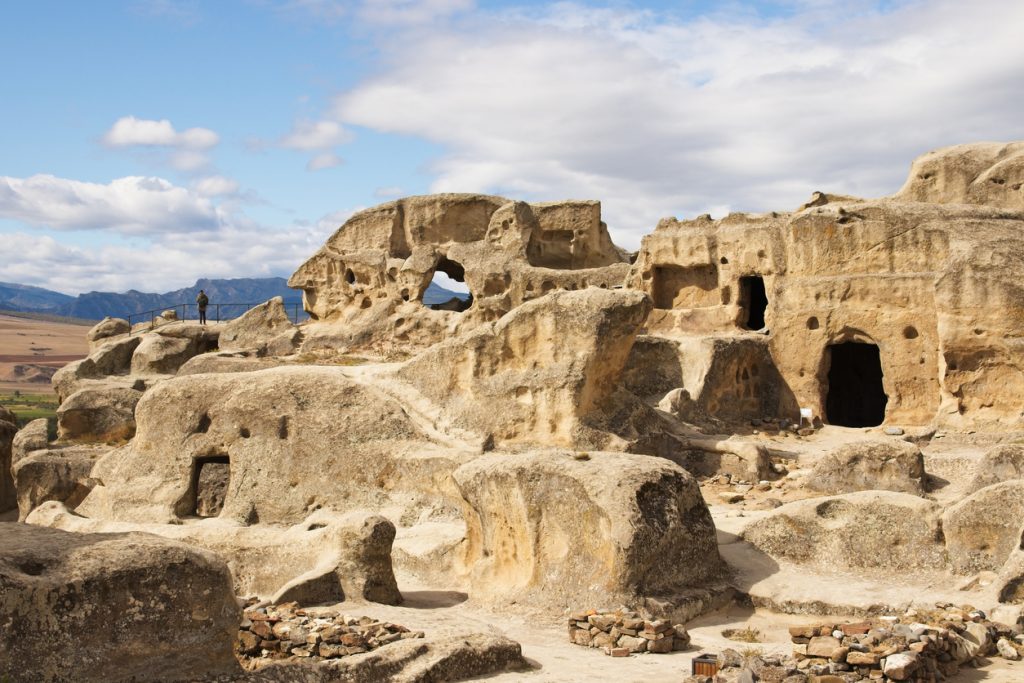 A low angle shot of the ancient rock-hewn town Uplistsikhe  in Georgia