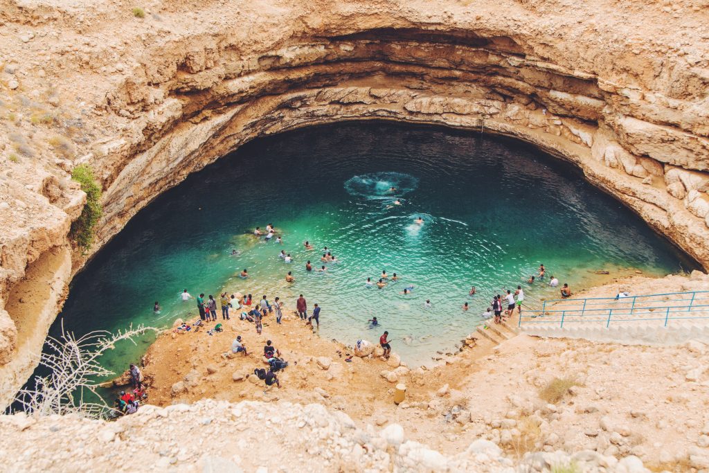 People swimming in Bimmah Sinkhole, Oman