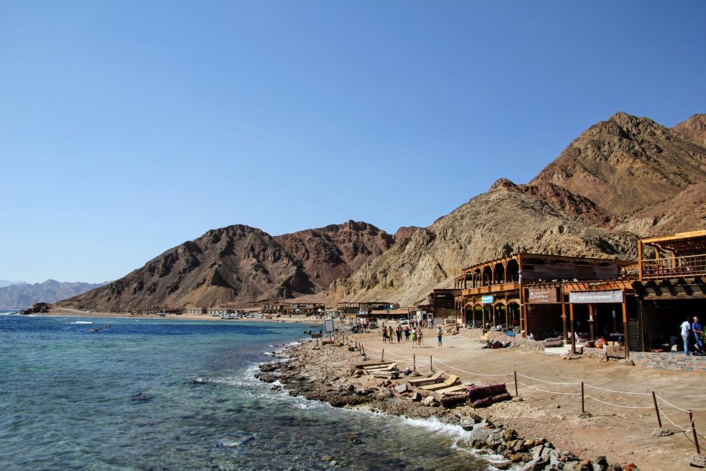 People walking along the beach in Dahab, Egypt