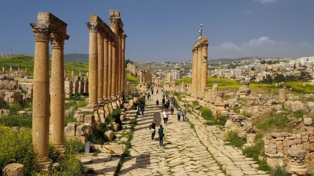 People walking in front of a monument in Amman, Jordan.